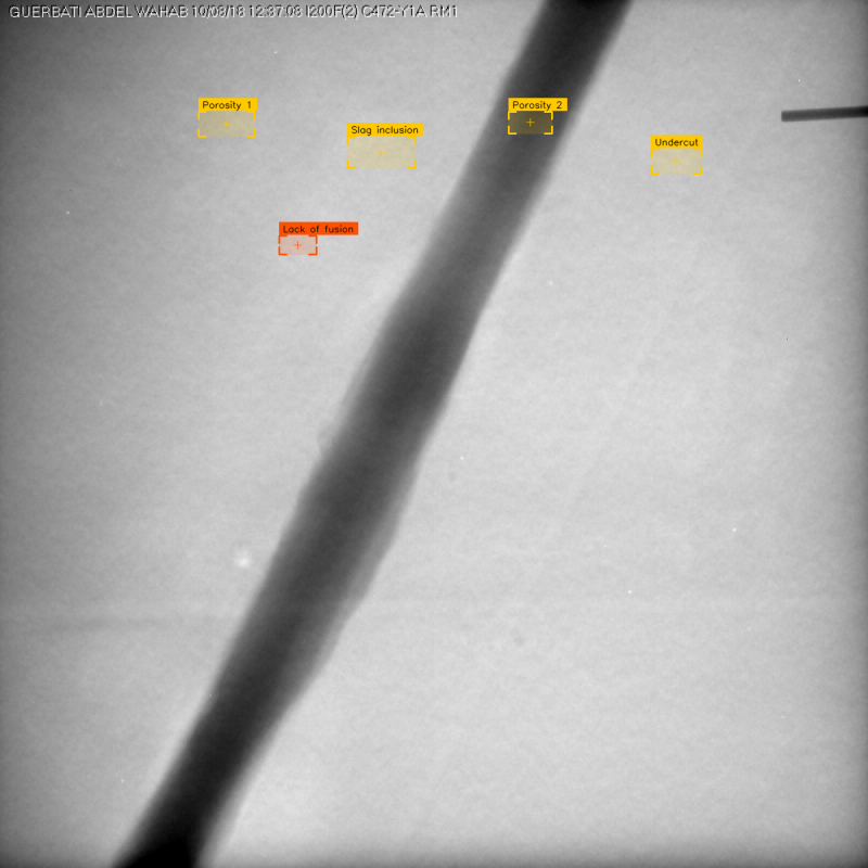 Inspector reviewing weld radiograph